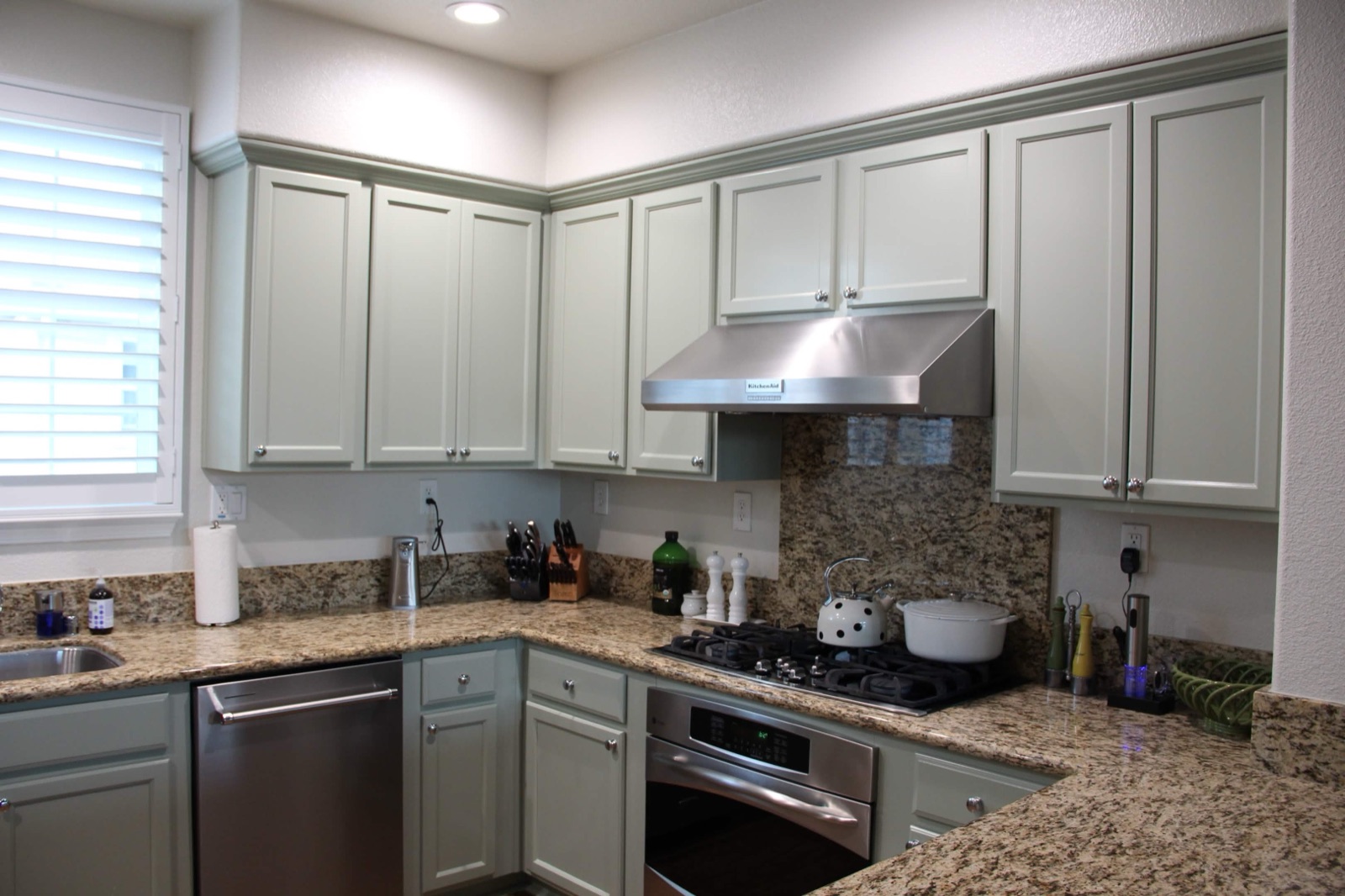 Refinished sage-green kitchen cabinets