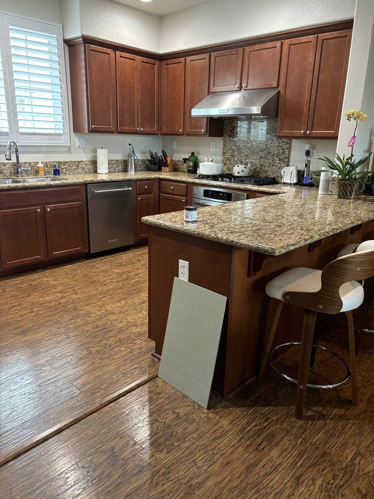 Kitchen with dark cherry-wood cabinets before refinishing