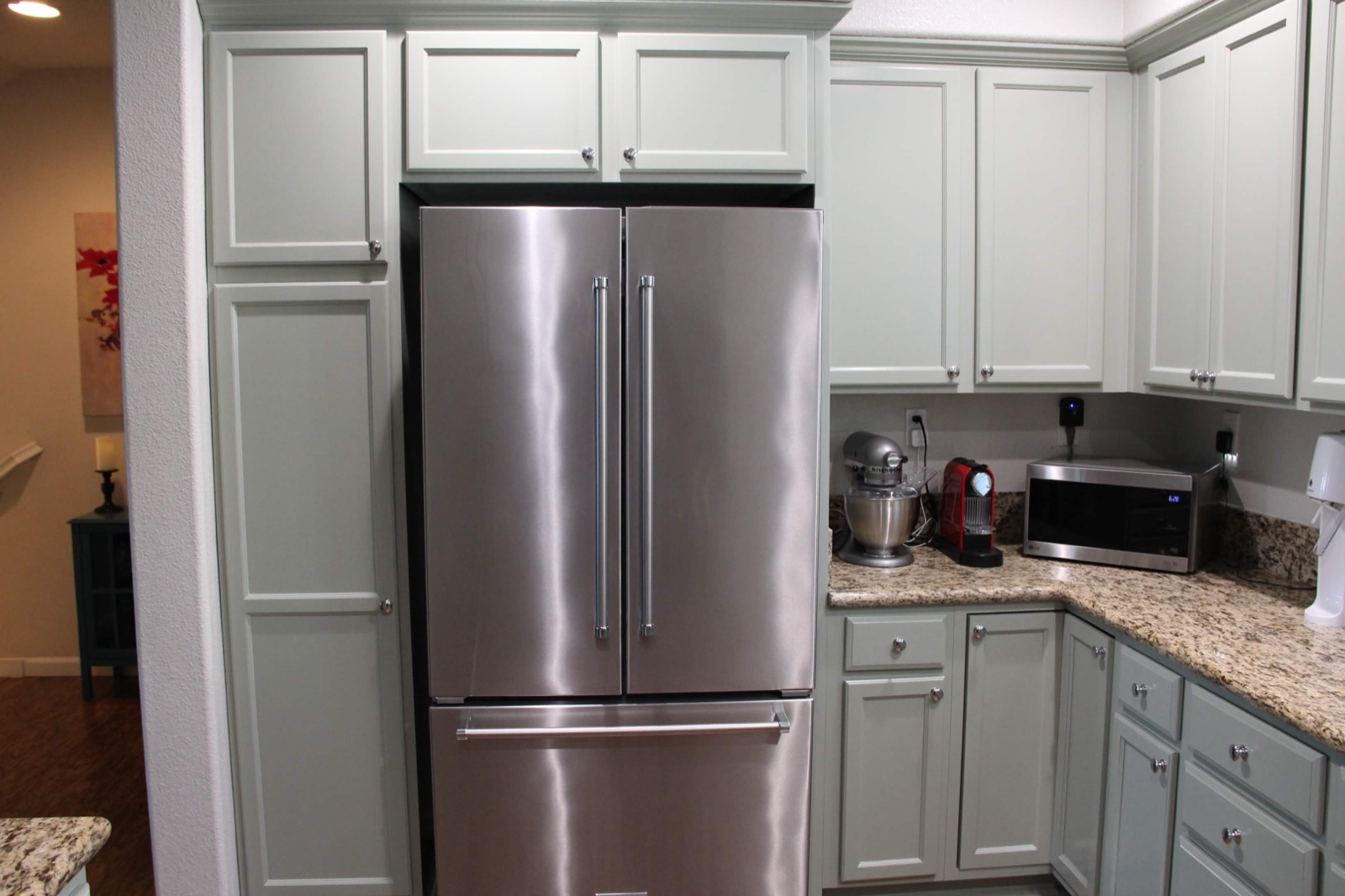 Sage green refinished kitchen cabinets